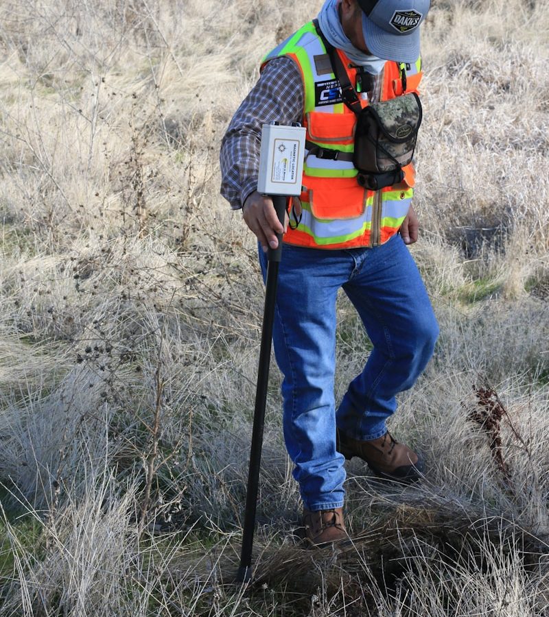 Photo by Scott Blake man in orange and black backpack and blue denim jeans standing on brown grass field during